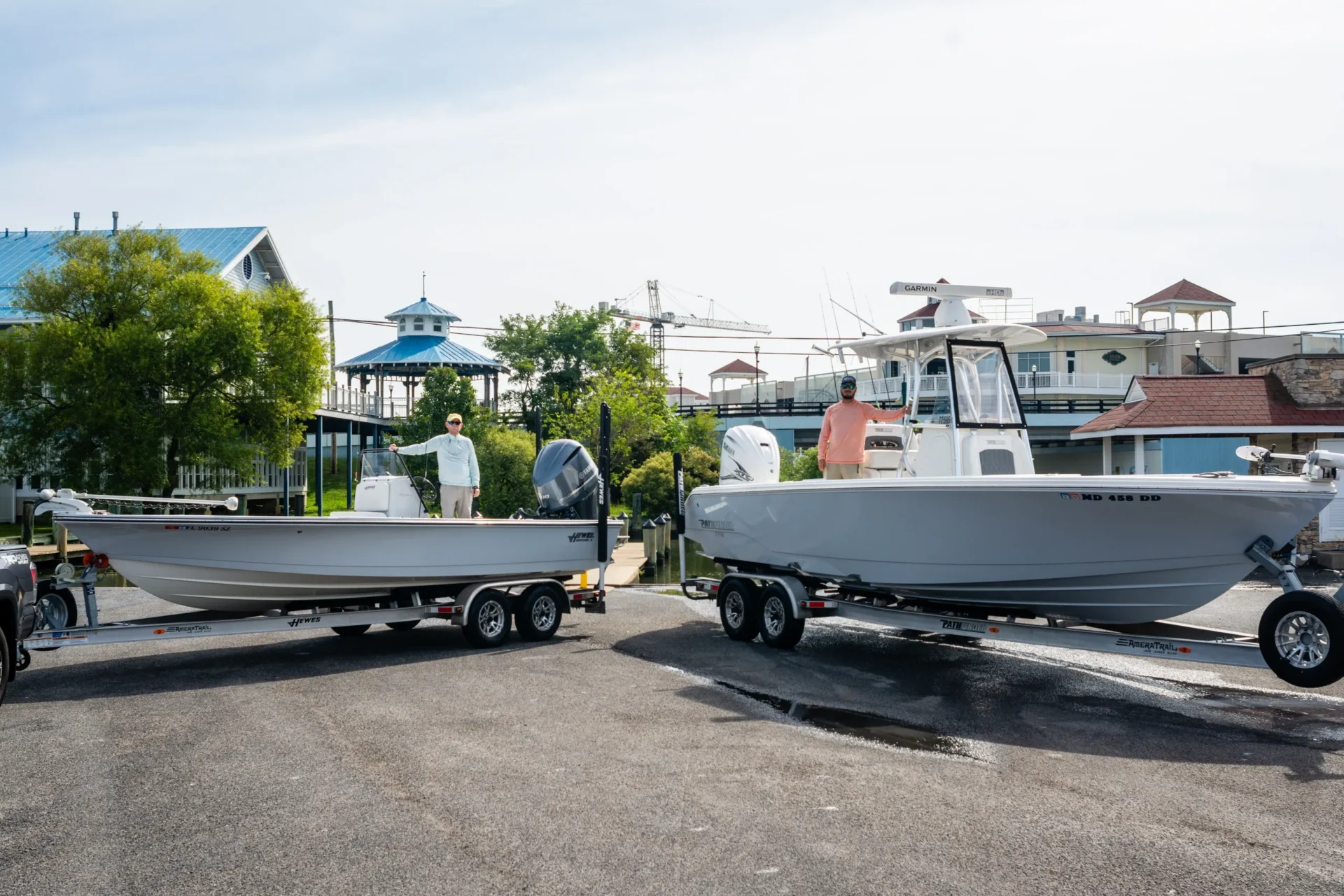 Two boats are parked in a parking lot.